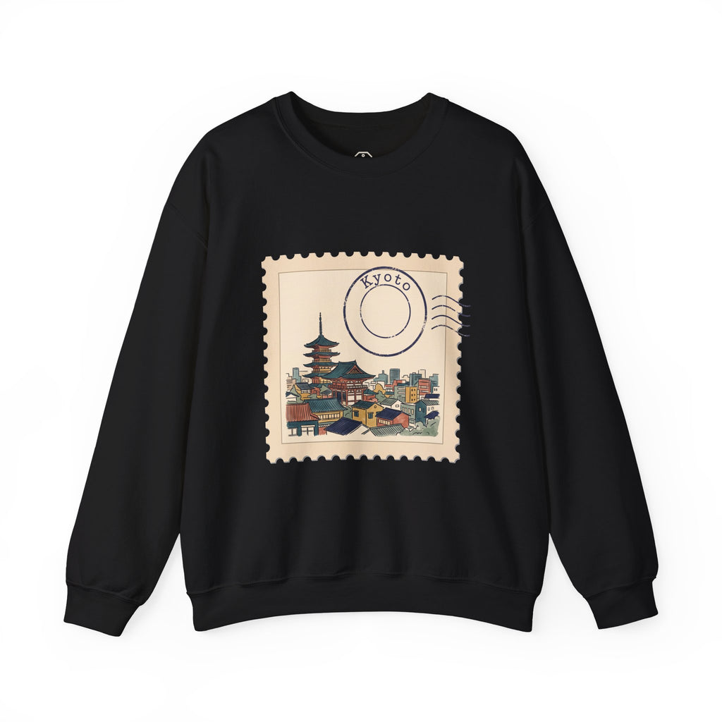 White crewneck sweatshirt featuring a vintage postage stamp illustration of the Kyoto skyline in watercolor with a postmark.